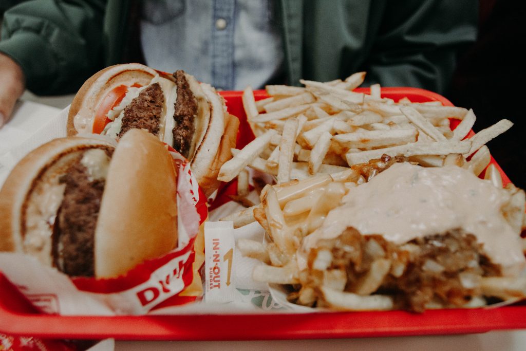 Tucking into a burger and fries. Only an estimated 5% of Americans eat enough fibre. 